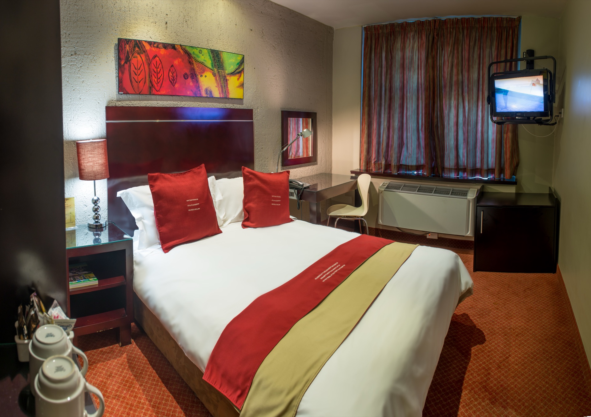 Classic Double room at Metcourt Inn, Gaborone with bedside tea tray and wall-mounted television