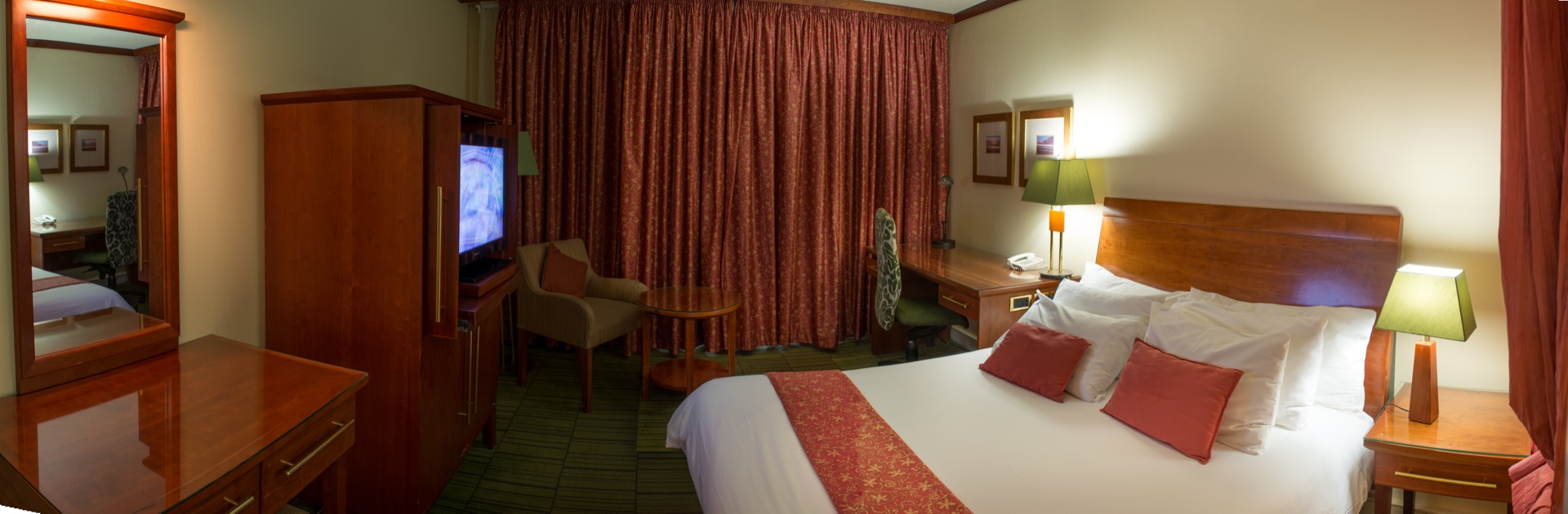 Classic King room featuring king bed, work desk and television at the Walmont, The Grand Palm, Gaborone
