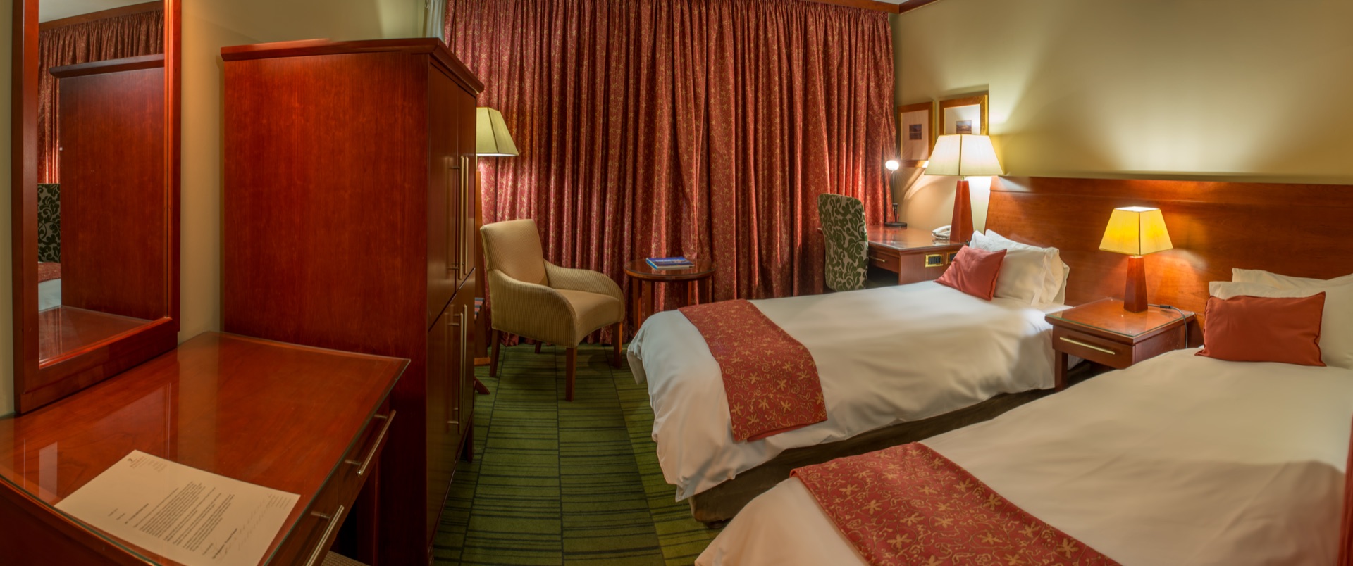 Classic Twin room with two beds, armchair and warm lamps at the Walmont, The Grand Palm, Gaborone