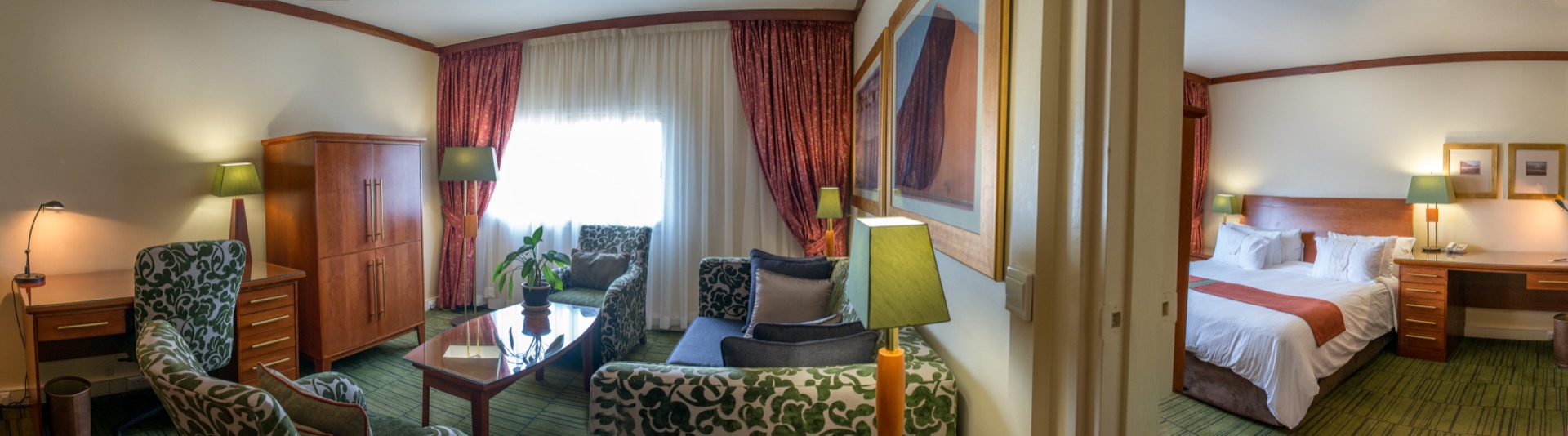 Executive Suite lounge with patterned sofas beside the king bedroom at the Walmont, The Grand Palm, Gaborone