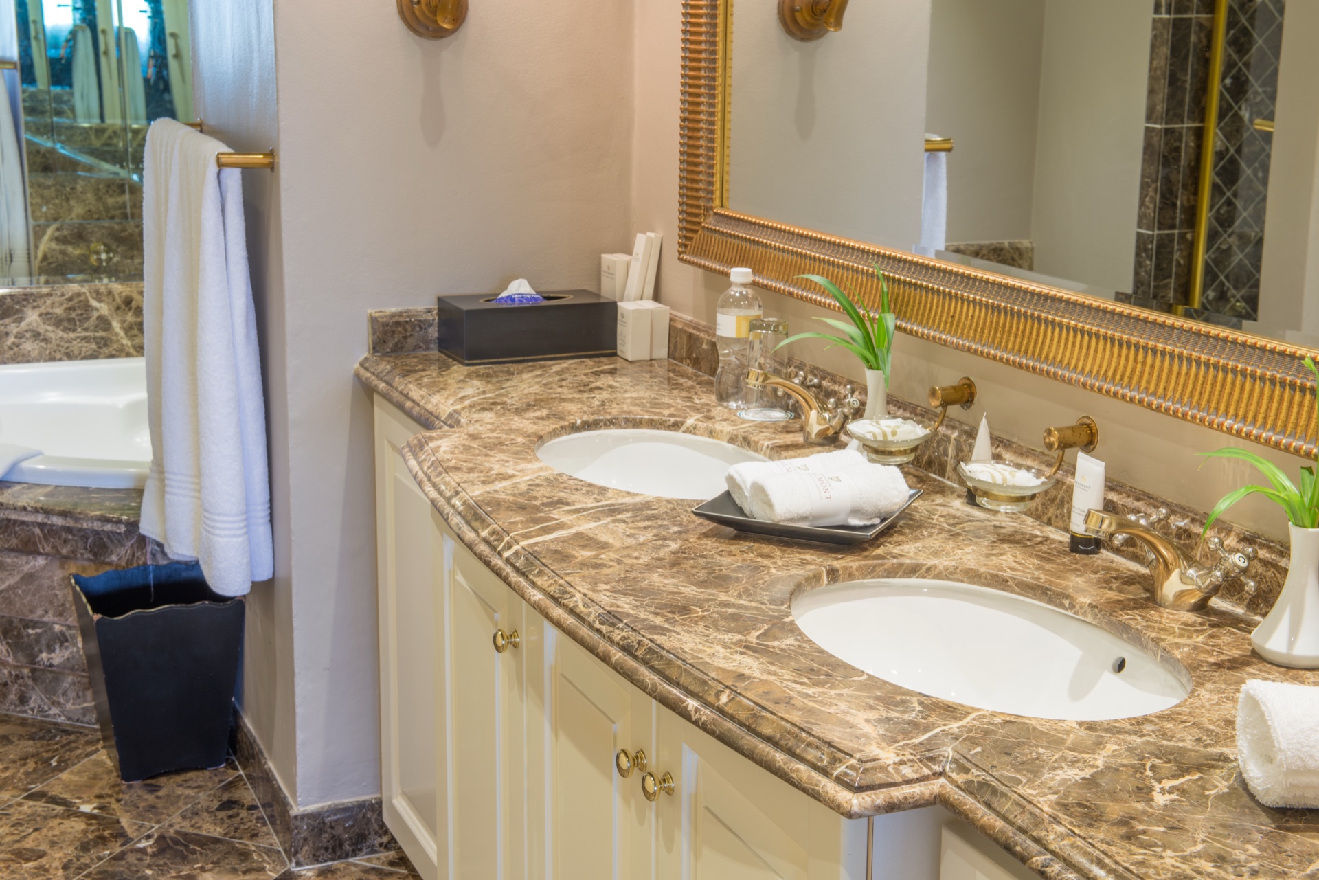 Presidential Suite bathroom with twin basins on marble vanity and gold taps at the Walmont, The Grand Palm, Gaborone