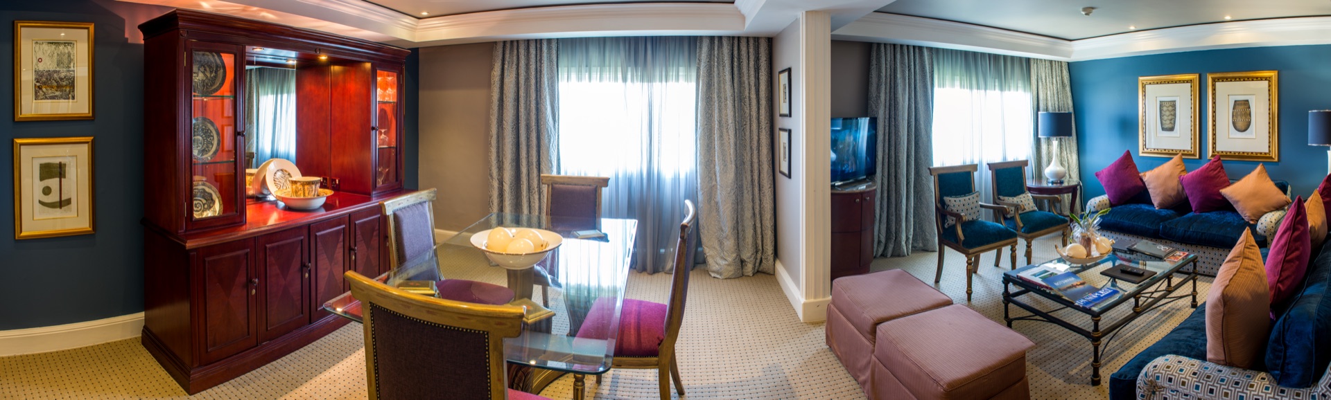 Presidential Suite lounge and study with dining setting and sofas at the Walmont, The Grand Palm, Gaborone