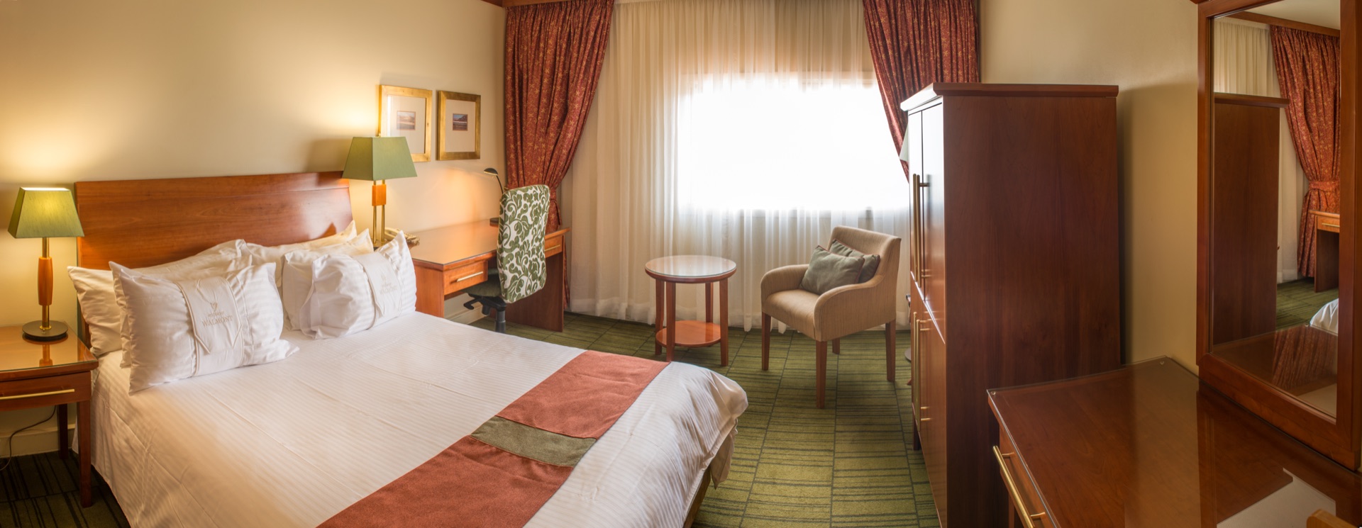Superior King room with double bed, work desk and armchair at the Walmont, The Grand Palm, Gaborone